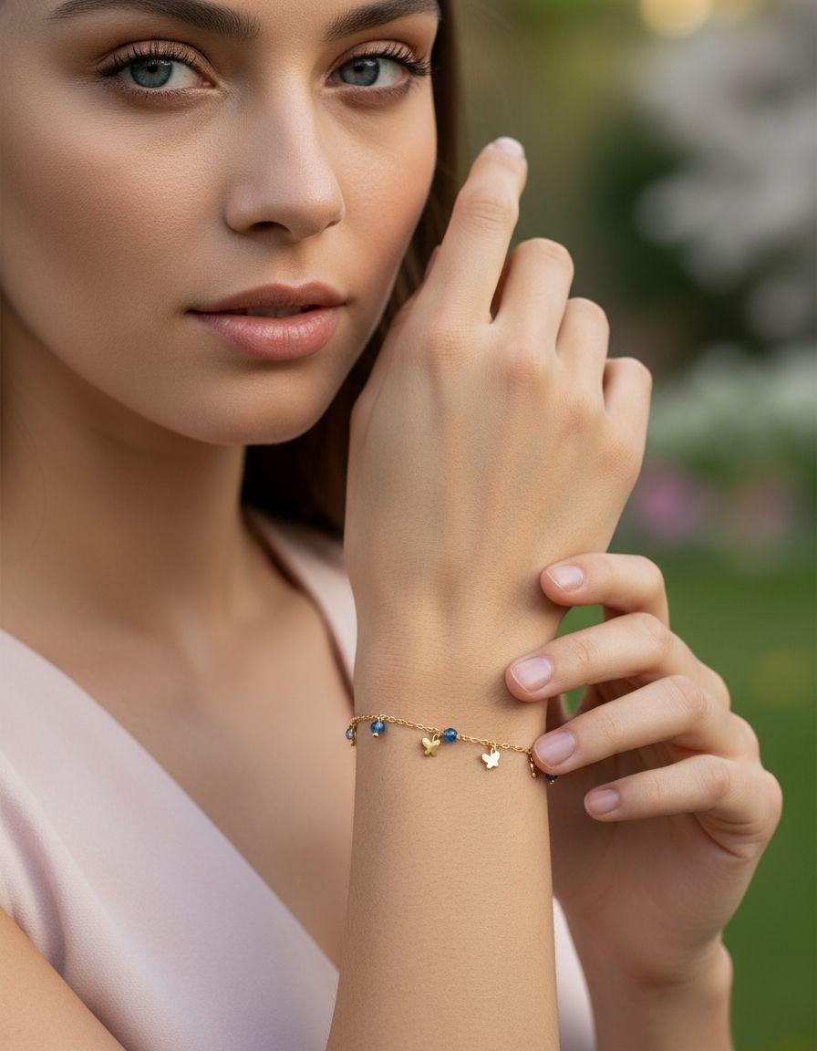 BRACELET EN ACIER DORE  PAPILLONS AVEC BILLES TURQUOISE