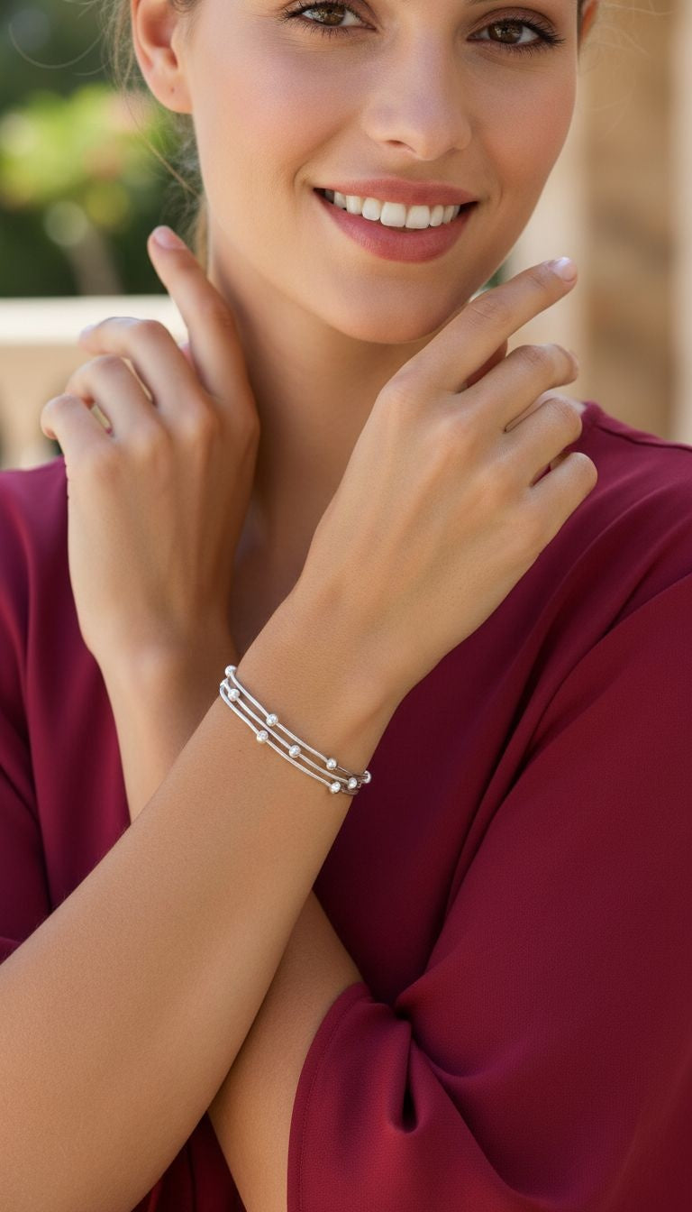 VERGULDE STALEN DRIESCHAKELARMBAND MET KRALEN