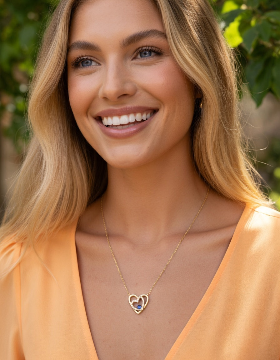 COLLIER EN PLAQUE OR DOUBLE COEURS ENTRELACE AVEC ZIRCONIUM ET SOLITAIRE LIGHT BLUE